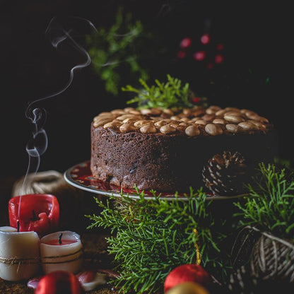 Chocolate cake with nuts on a dark background with decorative elements