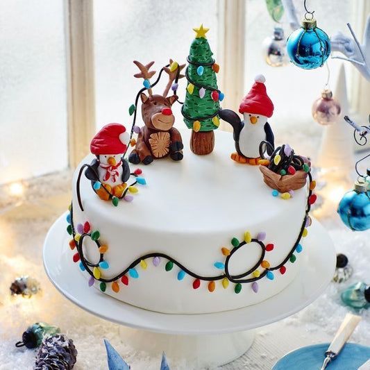 “Holiday Sparkle Cake” with gold dust and shimmering snowflakes
