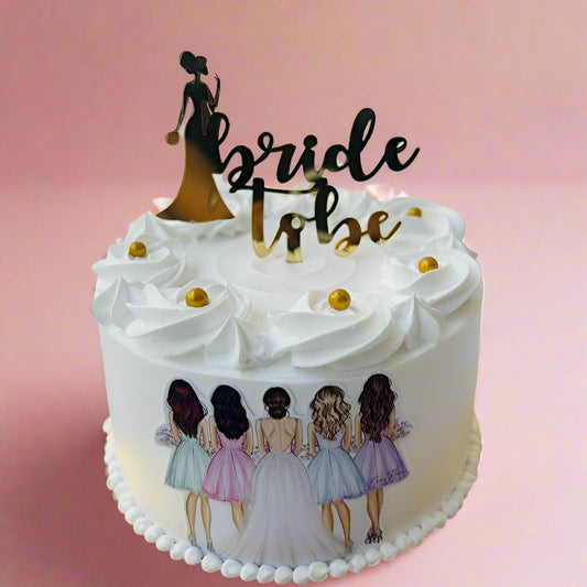 “Miss to Mrs.” cake with gold lettering and bridal charm