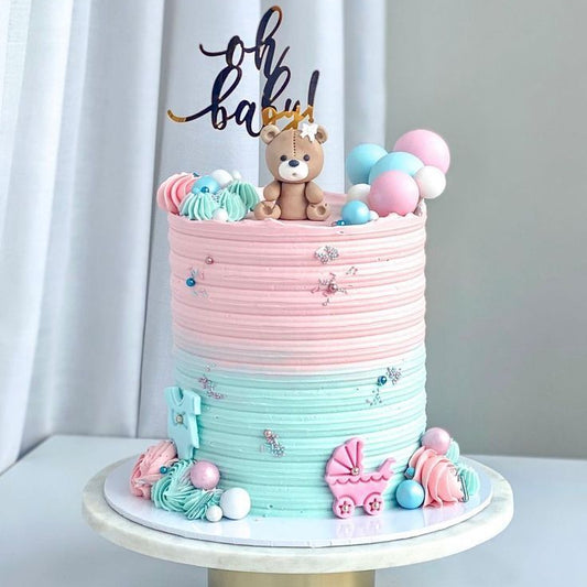 “Oh Baby! Cake” with bold lettering and baby shower charm